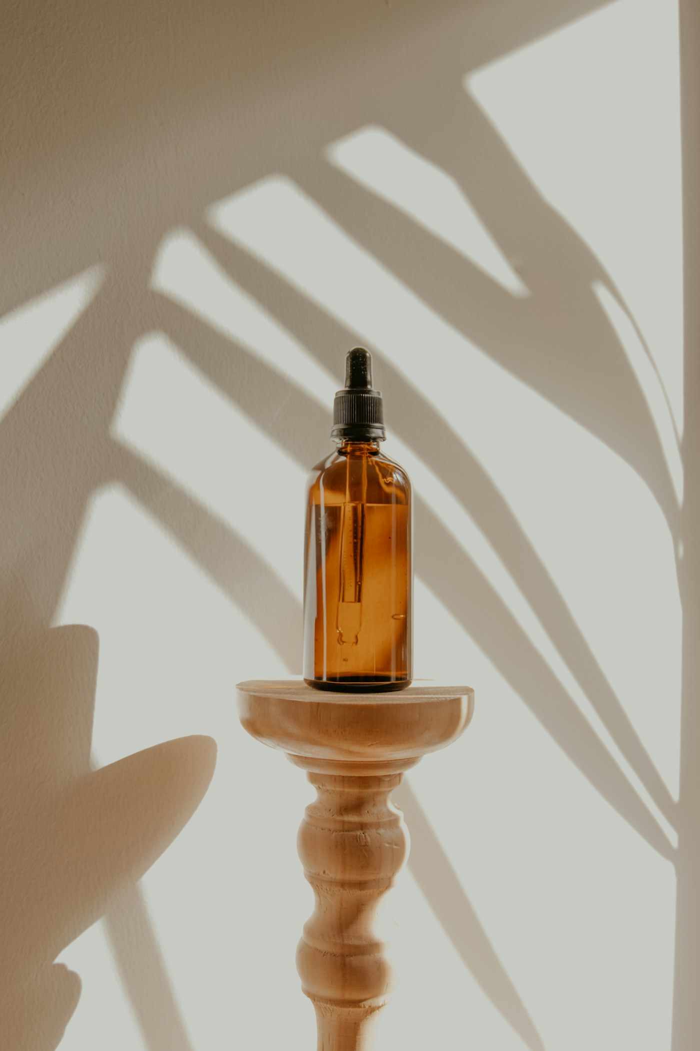 Amber skincare bottle staged against a clean studio background