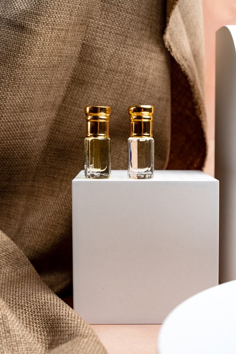 Luxury fragrance editorial shot with glass reflections and podium